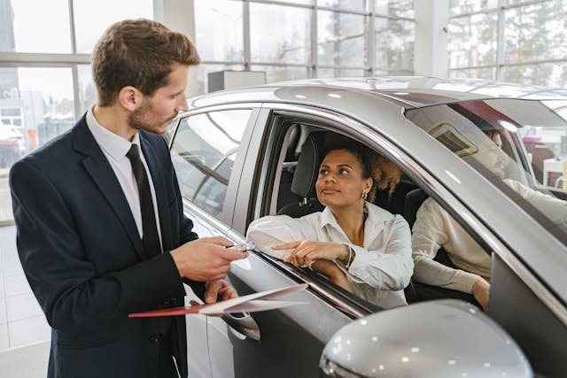 Une femme dans une concession réalisant une acquisition.